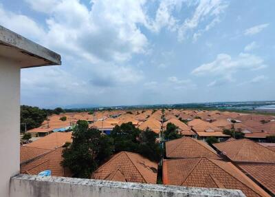 Expansive view from the balcony overlooking a residential area with red rooftops