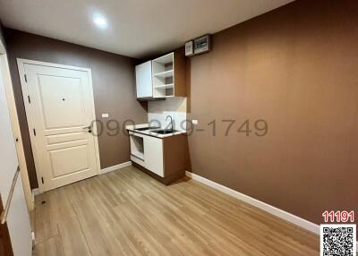 Compact modern kitchen with wooden floors and built-in shelves