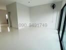 Spacious and brightly lit unfurnished living room with large window