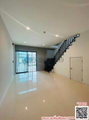 Spacious interior with glossy floors and staircase