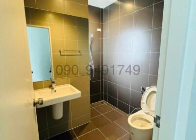 Compact bathroom with modern fixtures and tiles