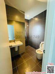 Compact bathroom with modern fixtures and tiles