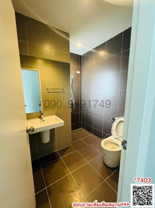 Compact bathroom with modern fixtures and tiles