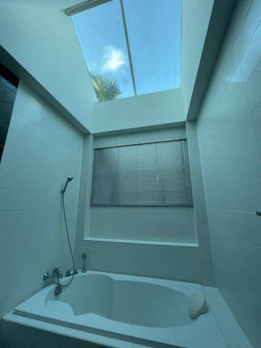 Modern bathroom with skylight and bathtub