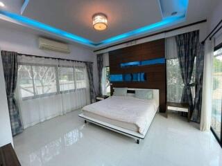 Modern bedroom with large bed and ambient lighting