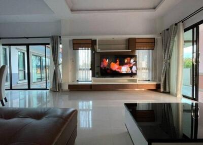 Spacious living room with large windows and modern entertainment system