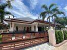 Spacious detached house with palm trees and a clear blue sky