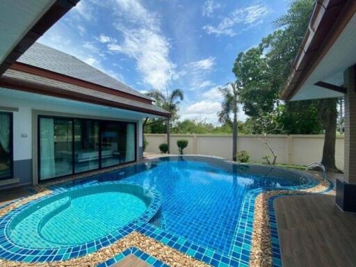 Spacious outdoor area with a private swimming pool and patio by a residential property