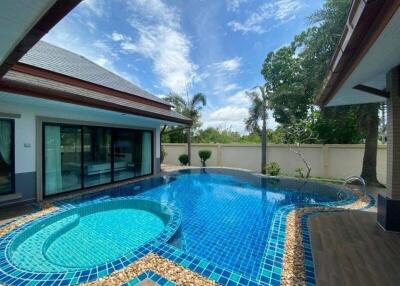 Spacious outdoor area with a private swimming pool and patio by a residential property