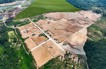 Aerial view of a land development site adjacent to green fields