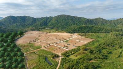 Aerial view of a rural land development surrounded by forested hills