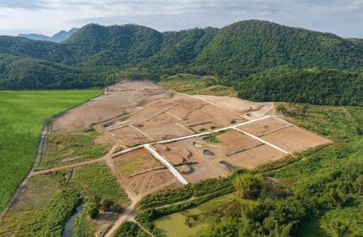 Aerial view of a development site surrounded by greenery