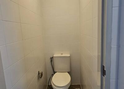 Compact bathroom with white tiles and modern toilet