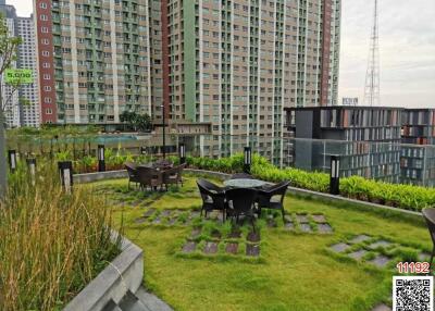 Rooftop garden with seating area in a high-rise residential building