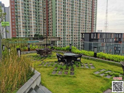 Rooftop garden with seating area in a high-rise residential building