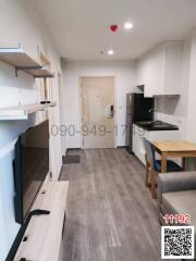 Modern kitchen with wooden shelves and laminate flooring