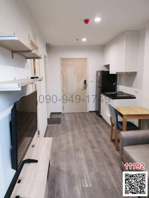 Modern kitchen with wooden shelves and laminate flooring