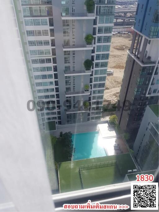 High-rise apartment building with swimming pool and sports court viewed from a window