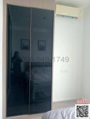 Modern bedroom with mirrored closet and air conditioning unit
