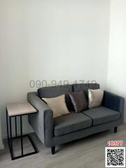 Cozy living area with a modern grey sofa and side table