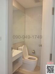 Compact white bathroom with toilet and sink