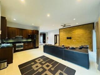 Spacious living room with modern kitchen in the background