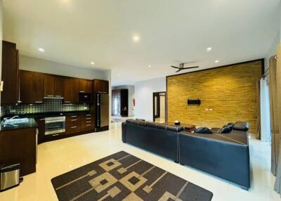 Spacious living room with modern kitchen in the background
