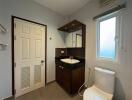 Compact bathroom with modern fixtures and window