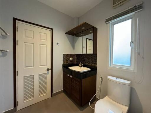 Compact bathroom with modern fixtures and window