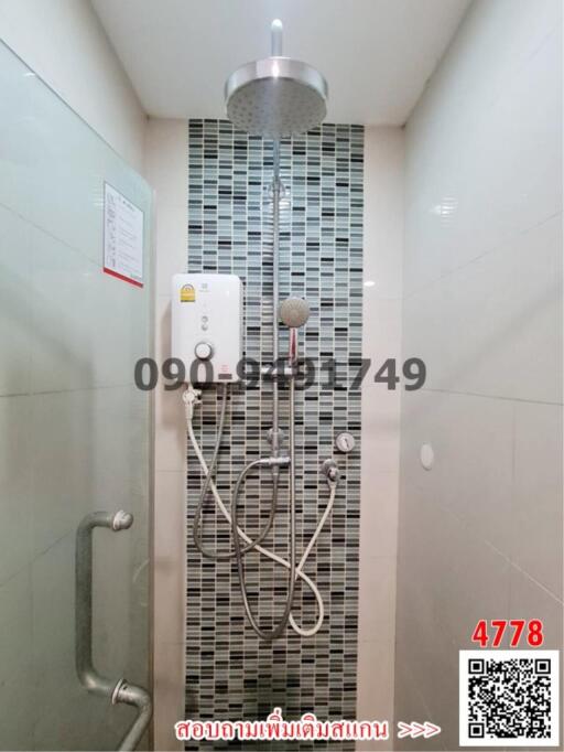 Modern bathroom with wall-mounted shower system and decorative tiles