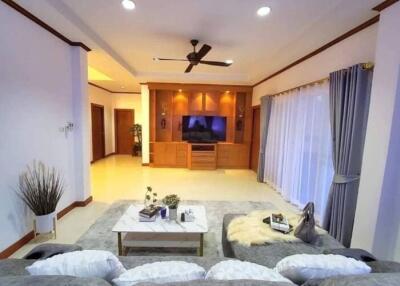Spacious living room with modern furniture and large screen TV