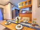 Cozy dining area with a wooden table set and modern kitchenette in the background