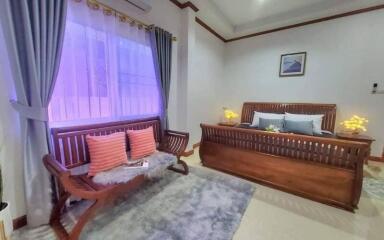 Elegantly furnished bedroom with king-sized bed and cozy seating area