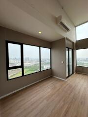 Spacious and bright living room with large windows and city view