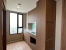 Cozy bedroom with wooden wardrobe and ample natural light from the window