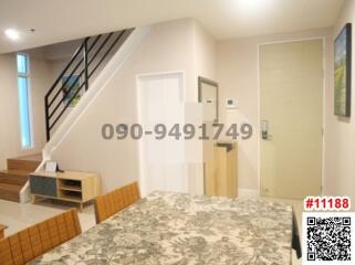 Bright and modern entrance space with staircase and stylish rug