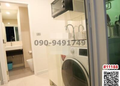 Compact laundry room with modern washer and dryer, and ample shelving