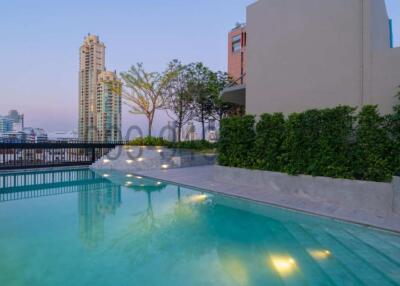 Rooftop swimming pool with city skyline in twilight