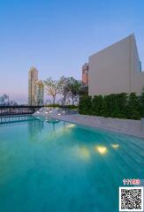 Rooftop swimming pool with city skyline in twilight