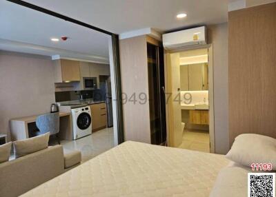 Compact bedroom with integrated living and kitchenette area