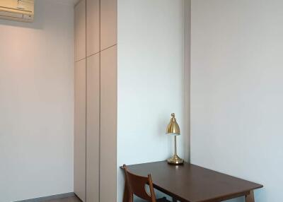 Minimalist bedroom with wooden furniture and built-in wardrobe