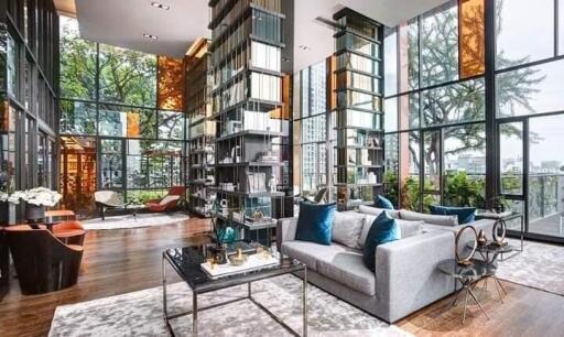 Spacious living room with floor-to-ceiling windows and modern furnishings