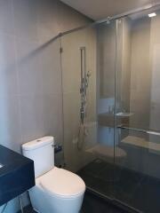 Modern bathroom with glass shower enclosure and toilet