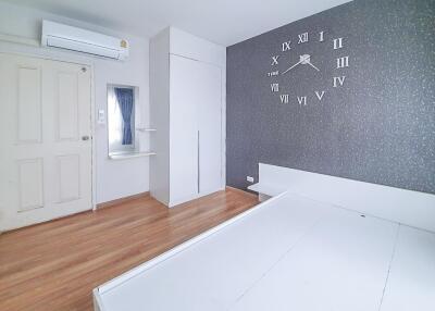 Spacious modern bedroom with large clock wall decoration