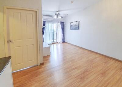 Spacious and well-lit living room with hardwood flooring