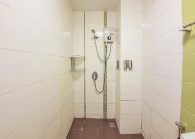 Cozy bathroom with a walk-in shower and tiled walls