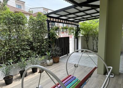 Cozy patio with a colorful bench and a pergola