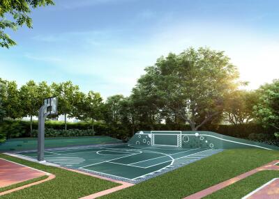 Outdoor basketball court and playground surrounded by lush greenery