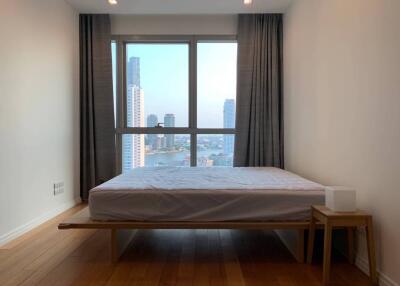 Minimalistic bedroom with large window and city view
