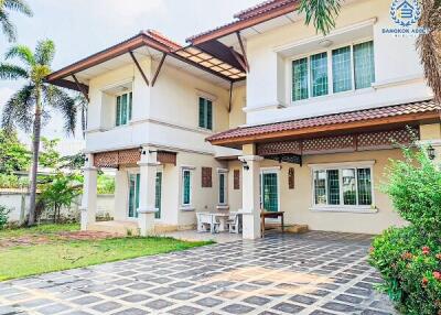 Spacious two-story suburban house with a tiled front yard and greenery